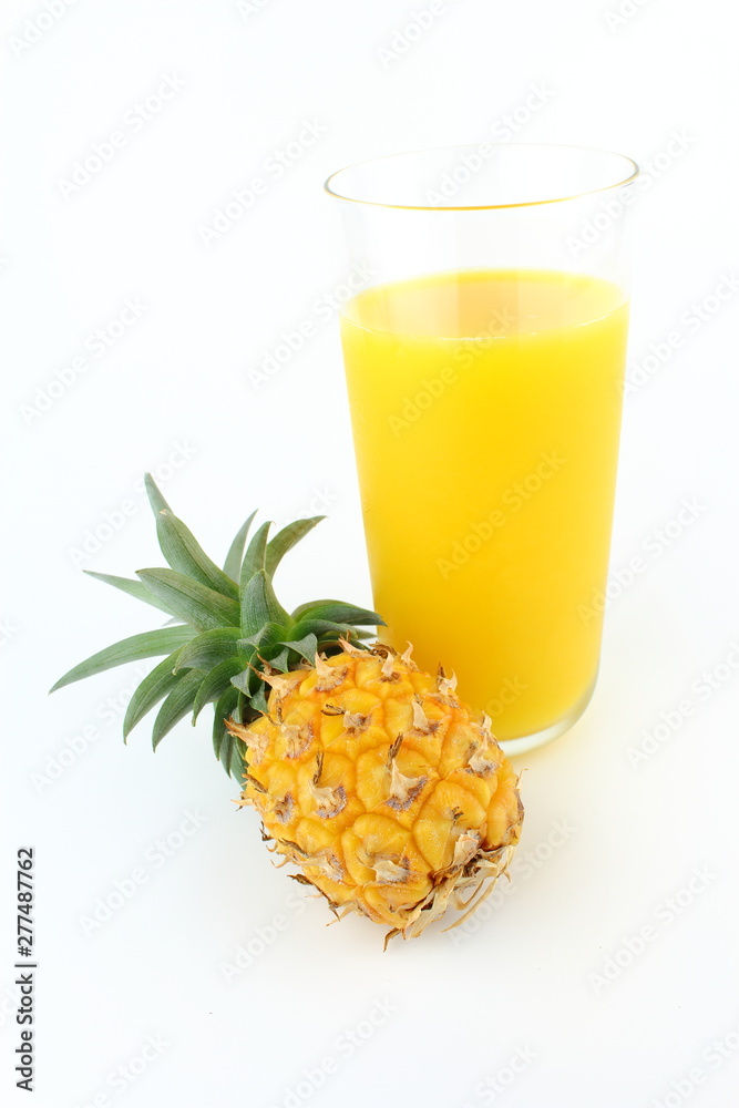 fresh pineapple and a glass of pineapple juice isolated on a white background with copy space fresh pineapple and a glass of pineapple juice isolated on a white background with copy space