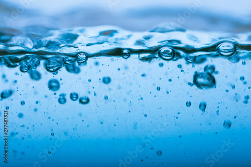 Water splash, clear blue water with waves and bubbless