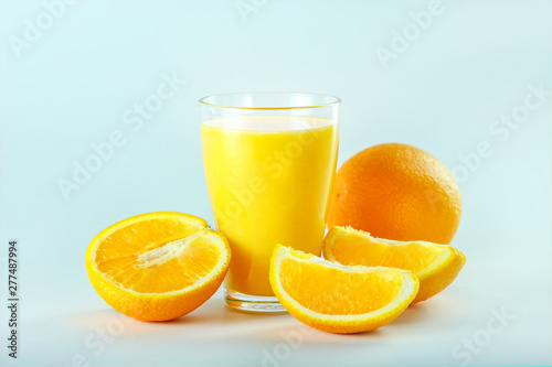 Glass with fresh orange juice with fruits, isolated.