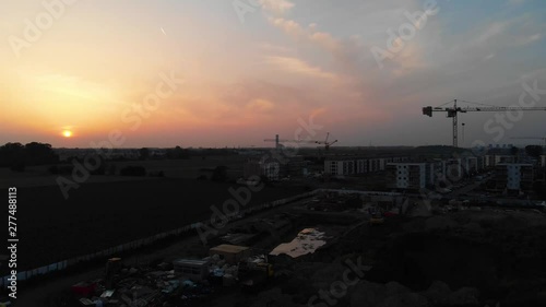 Sunset Aerial Panorama Over New Real Estate Buldings Construction Zove WIth Cranes Sithouettes photo