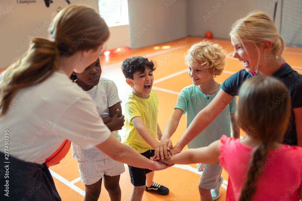 Classmates cheering up each other before game.