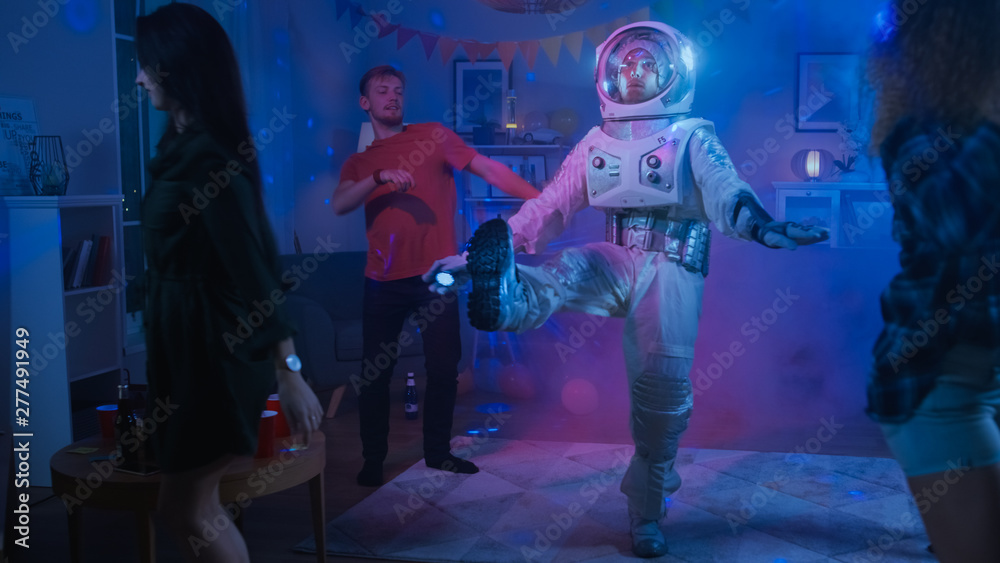 At the College House Costume Party: Fun Guy Wearing Space Suit Dances Off,  Doing Robot Dance Modern Moves. With Him Beautiful Girls and Boys Dancing  in Neon Lights. Stock-foto | Adobe Stock