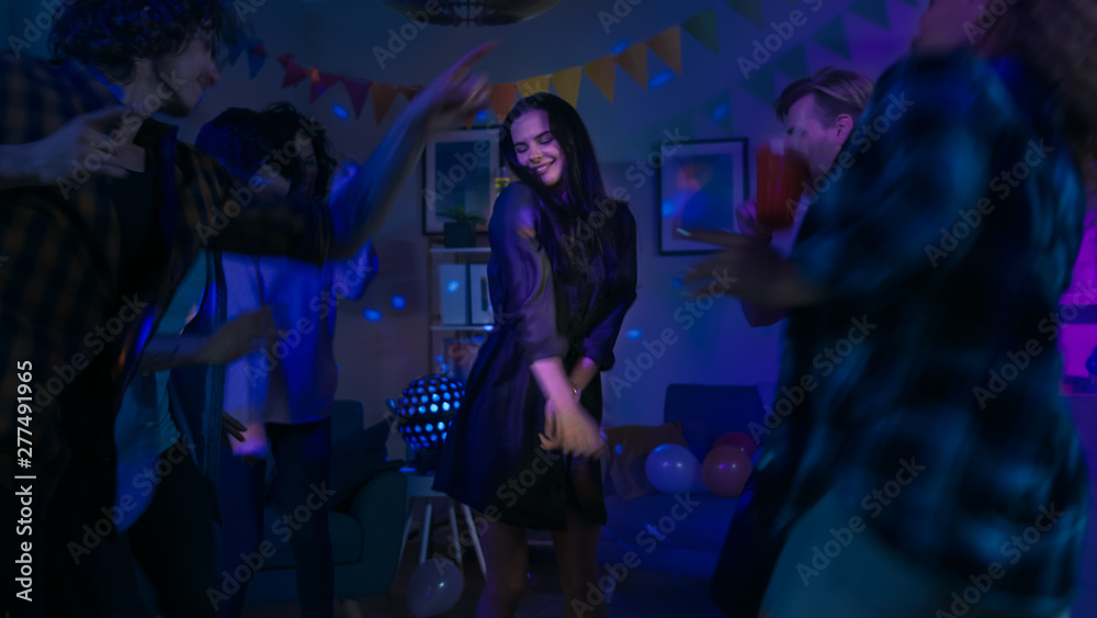 At the College House Party: Young Girl Dances in the Middle of a Circle of People. Diverse Group of Friends Have Fun, Dancing and Socializing. Disco Neon Strobe Lights Illuminating Room. At the College House Party: Young Girl Dances in the Middle of a Circle of People. Diverse Group of Friends Have Fun, Dancing and Socializing. Disco Neon Strobe Lights Illuminating Room.