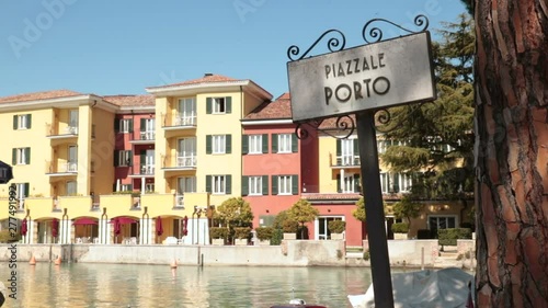 Old mediterranean port square. Detail of ancient signboard in sirmione harbour (