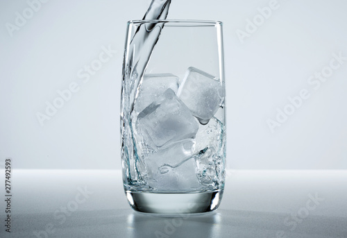 Beautiful splash of water in a glass with ice