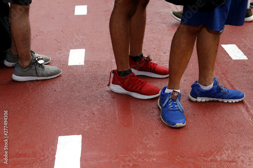 Feet of person wearing running or rubber shoes