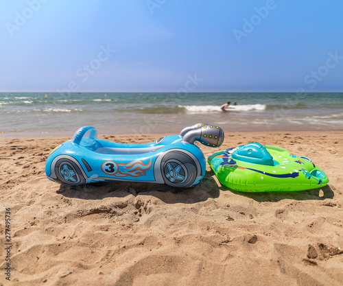 Water toys for little kids at a beautiful beach with no people. © allessuper_1979