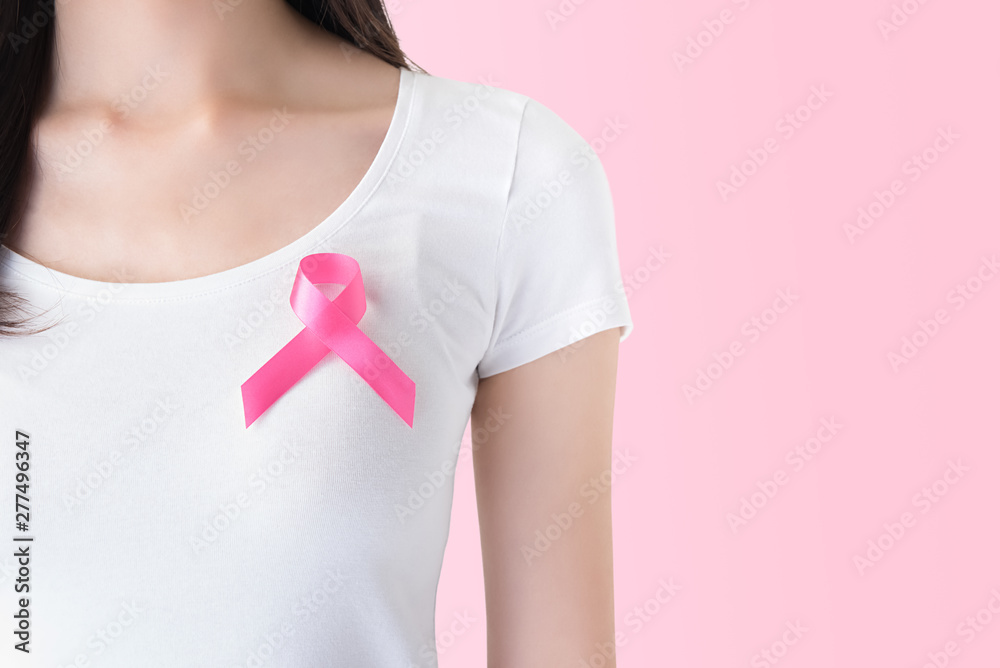 Woman in white t-shirt with pink ribbon breast cancer awareness campaign Woman in white t-shirt with pink ribbon breast cancer awareness campaign
