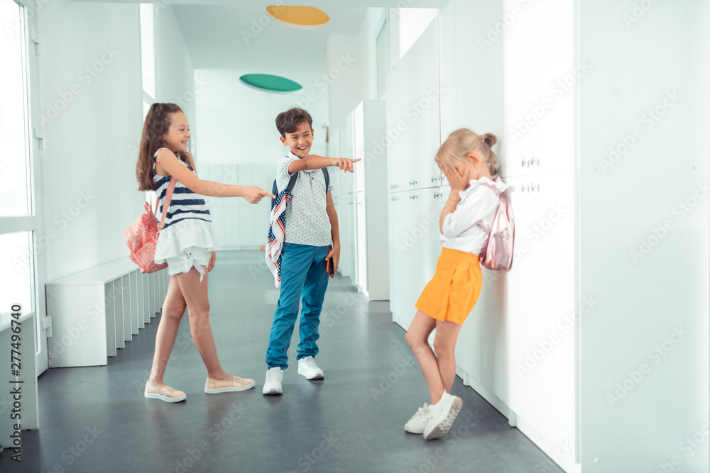 Fototapeta premium Little slim girl feeling lonely suffering from bulling