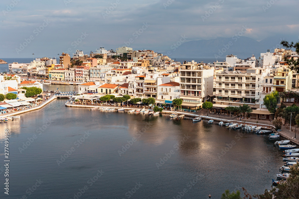 top view of the quiet bay with boats and the Greek resort town of Agios Nikolaos top view of the quiet bay with boats and the Greek resort town of Agios Nikolaos