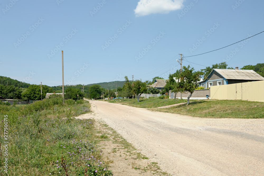 View of rural street, road, country houses and gardens . Crimea,Ukraine