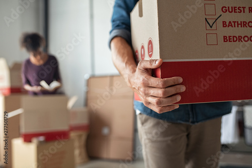 Hands holding cardboard box during relocation photo