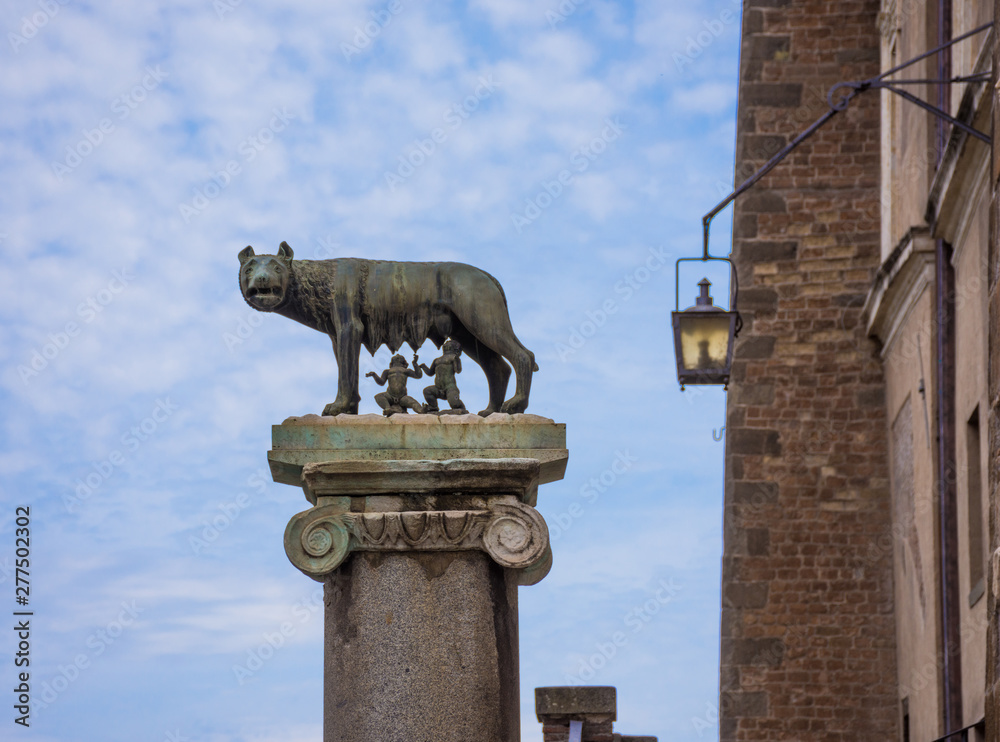 ROME, ITALY - MAY 3, 2019: The bronze statue of the Capitoline Wolf (Lupa Capitolina) feeding Romulus (founder of Rome) and Remus against blue sky