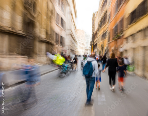 Busy city people going along the street. Intentional motion blur