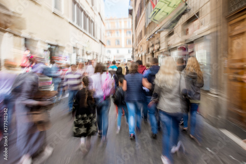 Busy city people going along the street. Intentional motion blur