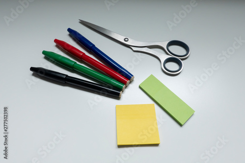 Image photograph of a four-color sign pen and stainless steel scissors for stationery