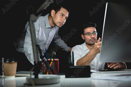 Aasian businessman coworkers discussing work at night photo