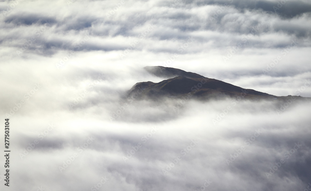 The summit of Great Rigg breaking through a cloud inversion in the English Lake District, UK.
