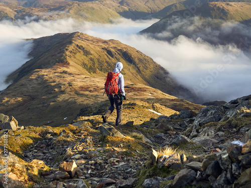 Canvas Print A hiker descending Hart Crag towards Hartsop Above How near Patterdale in the English Lake District