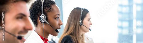Group of diverse telemarketing team in call center office banner background