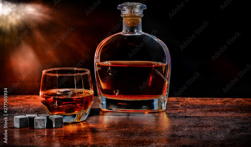Bottle and glass of brandy with reusable ice cubes