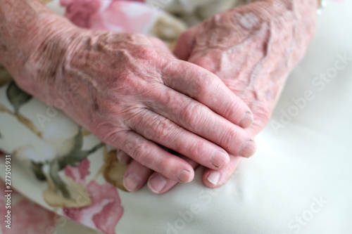 Hands of a very old woman close-up. Pearl bracelet on your wrist. Beautiful aging, time stamp