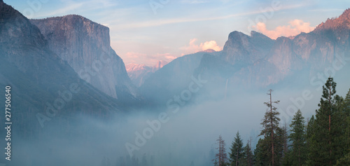 Classic Tunnel View of scenic Yosemite Valley with famous El Capitan and Half Dome rock climbing summits in beautiful misty atmosphere at morning in summer, Yosemite National Park, California, USA © Michal