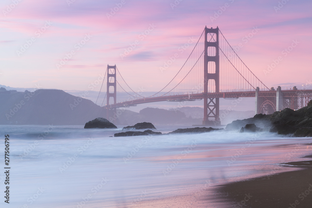 Classic panoramic view of famous Golden Gate Bridge seen from scenic Baker Beach in beautiful golden evening light on sunset with blue sky and clouds in summer, San Francisco, California, USA - obrazy, fototapety, plakaty 