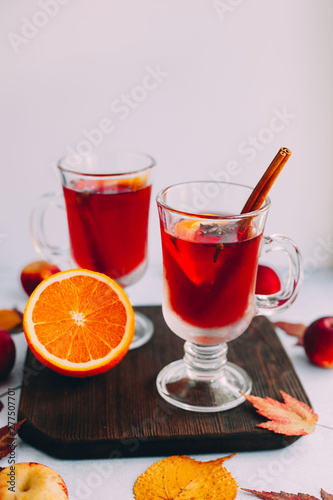  Hot red mulled wine with orange slice, anise and cinnamon sticks. 