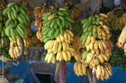 Bananas are sold on the market in Asia. Sale of vegetarian fruits outdoors. Stock photo