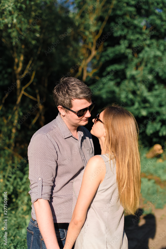 Fototapeta premium young couple in love on nature at sunset