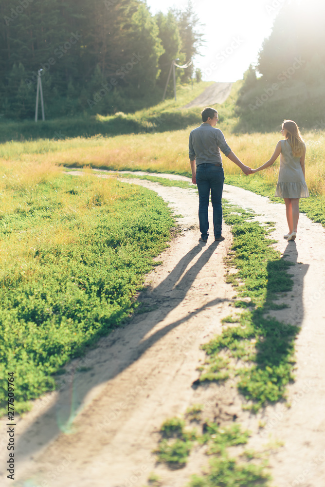 Fototapeta premium young couple in love on nature at sunset