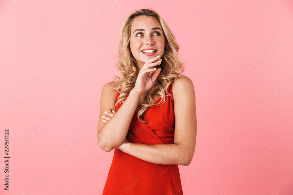 Young pretty blonde cute woman in dress posing isolated over pink wall background. Young pretty blonde cute woman in dress posing isolated over pink wall background.