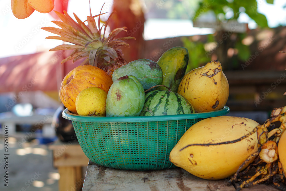 Yellow coconuts are sold on the market in Asia. Sale of vegetarian fruits outdoors. Stock photo