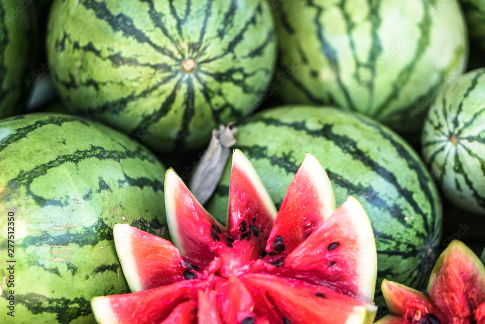 Watermelons and melons are sold on the market in Asia. Sale of vegetarian fruits outdoors. Stock photos Watermelons and melons are sold on the market in Asia. Sale of vegetarian fruits outdoors. Stock photos
