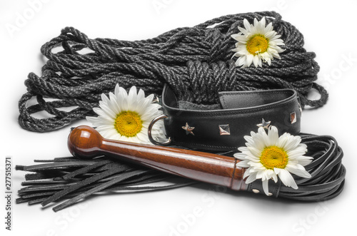 фотографія bdsm leather lash and black collar with shibari rope and yellow daisy flowers on