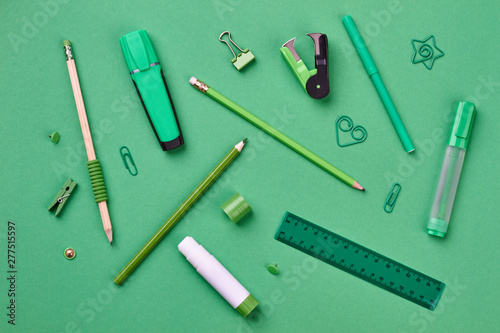 Stationery supplies on green background. Back to school concept.