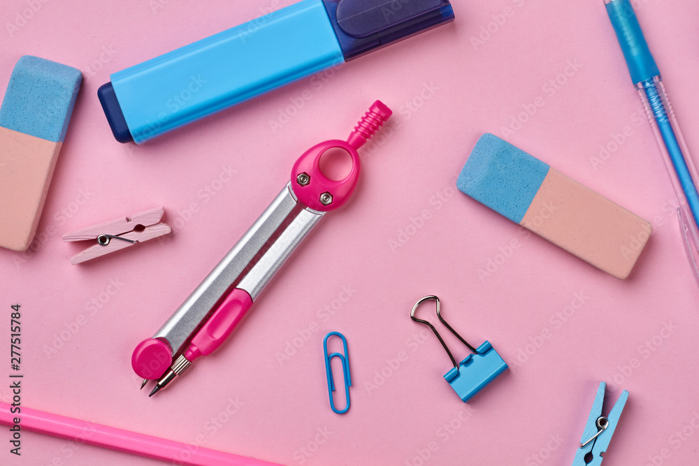 Different school supplies on pink background. Back to school background with various stationery accessories. Different school supplies on pink background. Back to school background with various stationery accessories.