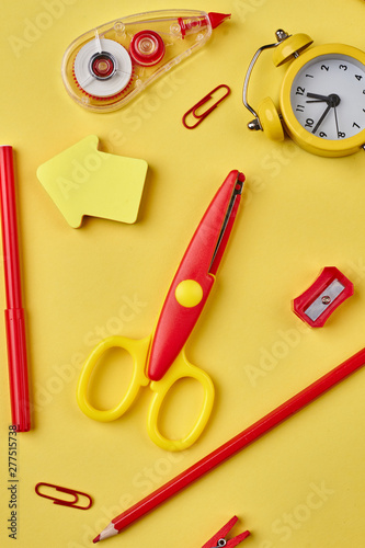 Back to school background. Colorful school supplies on yellow background. Flat lay, top view.