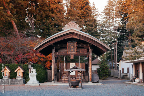 Morioka Hachimangu Shrine old Chouzuya water pavillion at sunset with warm tone light. Iwate, Japan photo