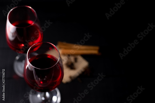 Red wine in glass on dark background.
