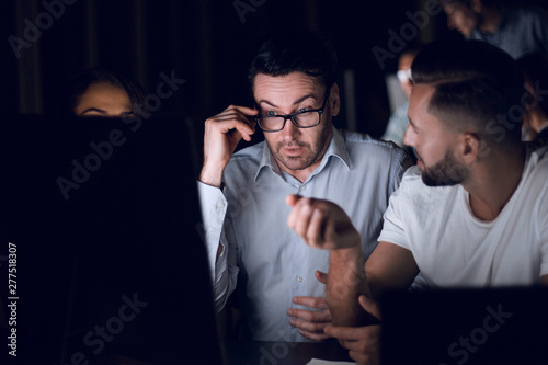 employees discussing financial data photo