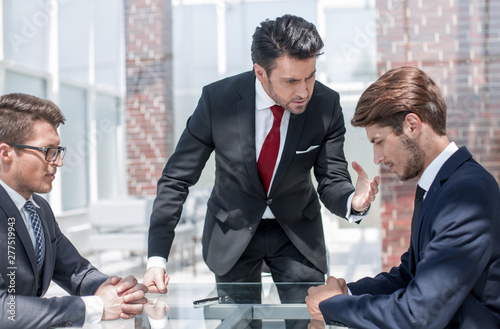 annoyed businessman scolds his employees