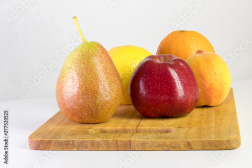 red apple, pear, lemon, orange, peach on white background, copy space