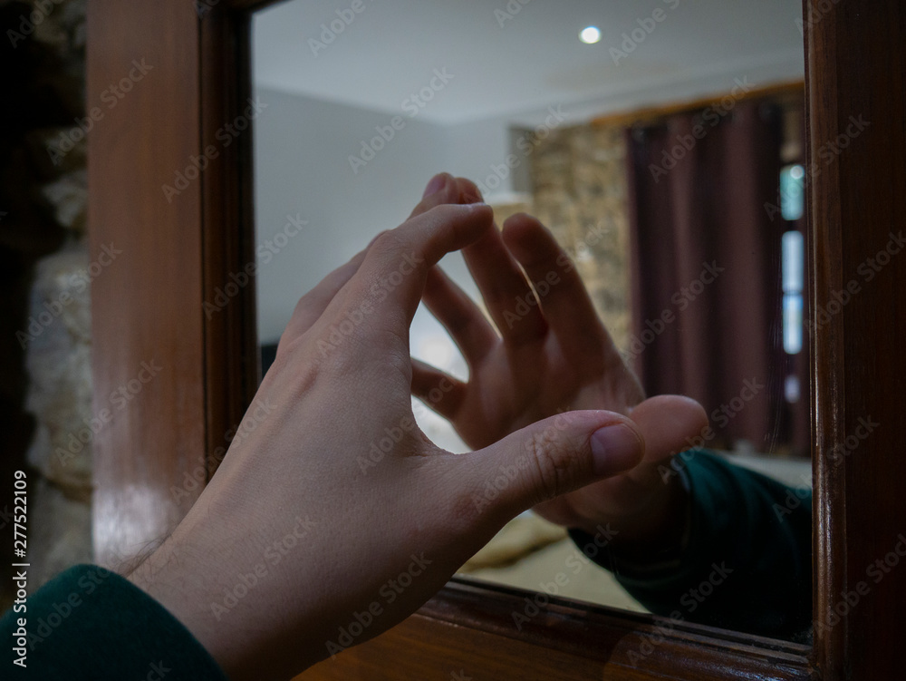 hand in front of mirror