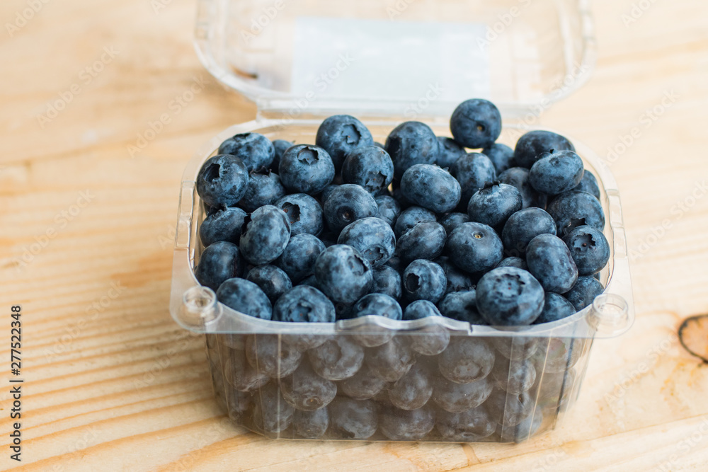 Many fresh bluederry on the wooden table close up Many fresh bluederry on the wooden table close up