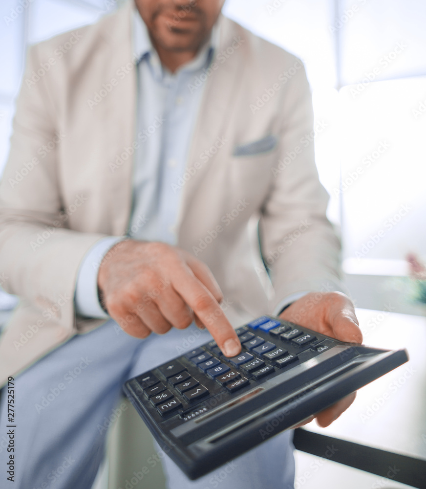 close up. businessman with calculator. close up. businessman with calculator.