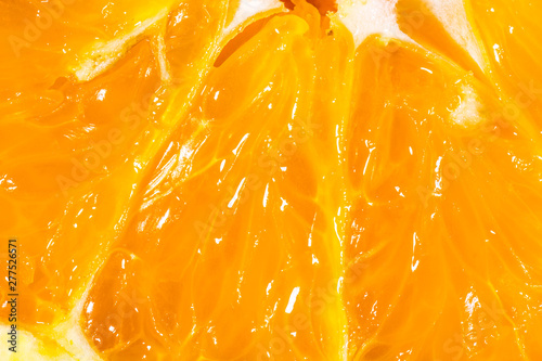 Closeup texture of an orange fruit slice. Fruit natural macro background