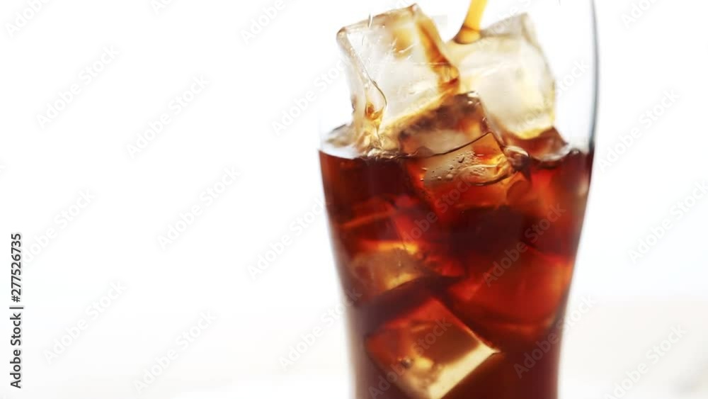 pouring cola into glass with ice on white background Video HD pouring cola into glass with ice on white background Video HD
