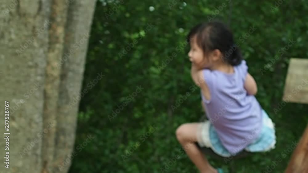 Little asian girl playing at playground,slow motion. Little asian girl playing at playground,slow motion.